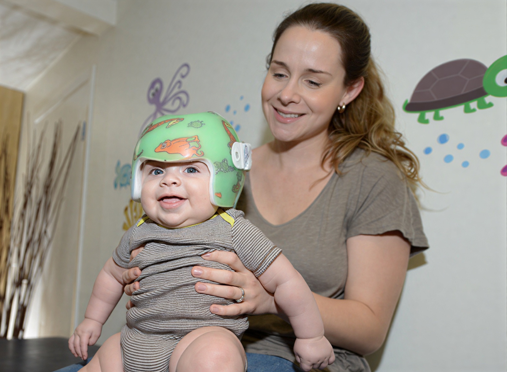 Parent holding baby during kinderBAND treatment